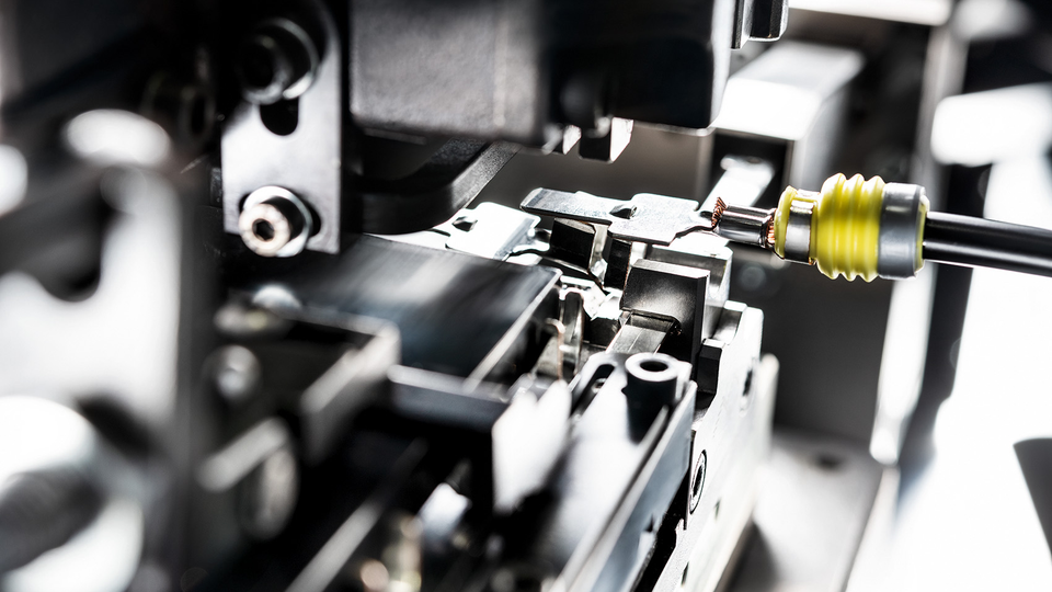 Close-up of terminal crimping tooling and wire termination